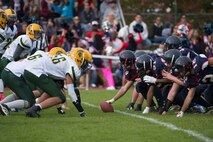The Bitburg Barons offense prepares to run a play during the Bitburg Middle High School homecoming football game at Bitburg Annex, Germany, Oct. 3, 2015. The Barons defeated the SHAPE Spartans 32-7. (U.S. Air Force photo by Staff Sgt. Christopher Ruano/Released)