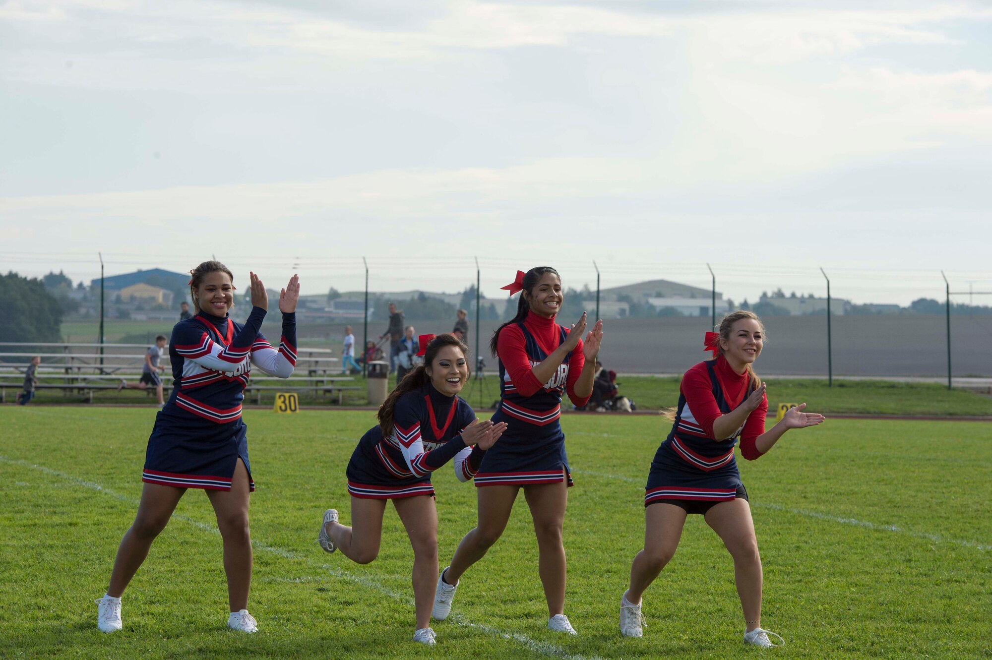 Bitburg Middle High School cheerleaders perform at halftime during the homecoming football game at Bitburg Annex, Germany, Oct. 3, 2015. The cheerleaders performed on the sidelines throughout the game supporting their team. (U.S. Air Force photo by Staff Sgt. Christopher Ruano/Released)