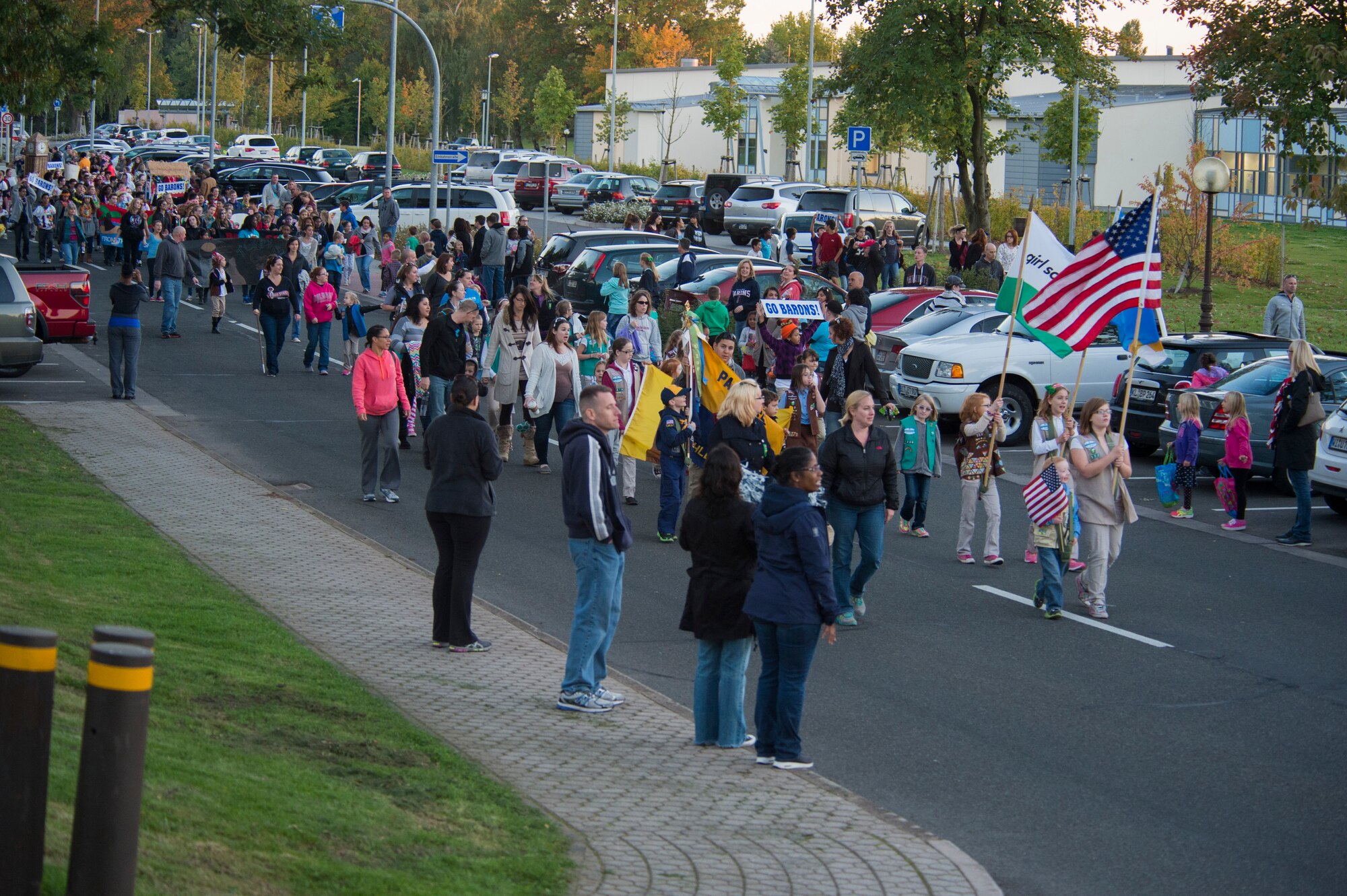 Spangdahlem community members parade down a street during a Homecoming parade at Spangdahlem Air Base, Germany, Oct. 2, 2015. More than 600 people participated in and viewed the parade that went through base housing and ended at the field across from Spangdahlem Elementary School. (U.S. Air Force photo by Airman 1st Class Luke Kitterman/Released)   