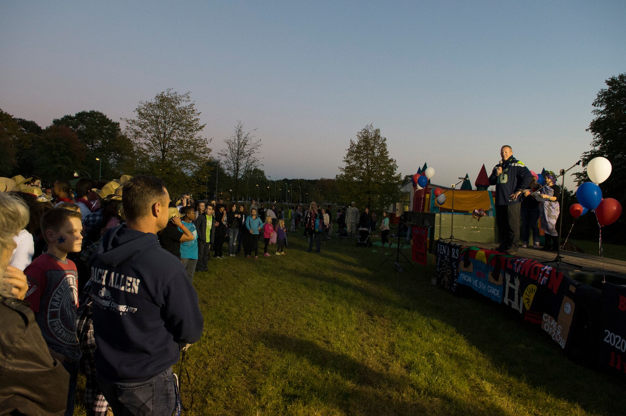 U.S. Air Force Col. Joe McFall, 52nd Fighter Wing commander, speaks to a crowd during a Homecoming pep rally at Spangdahlem Air Base, Germany, Oct. 2, 2015. The pep rally activities included a dance routine, a ‘pie-in-the-face’ event, announcement of Homecoming court nominations and recognition of the Bitburg Middle High School’s sports teams. (U.S. Air Force photo by Airman 1st Class Luke Kitterman/Released)