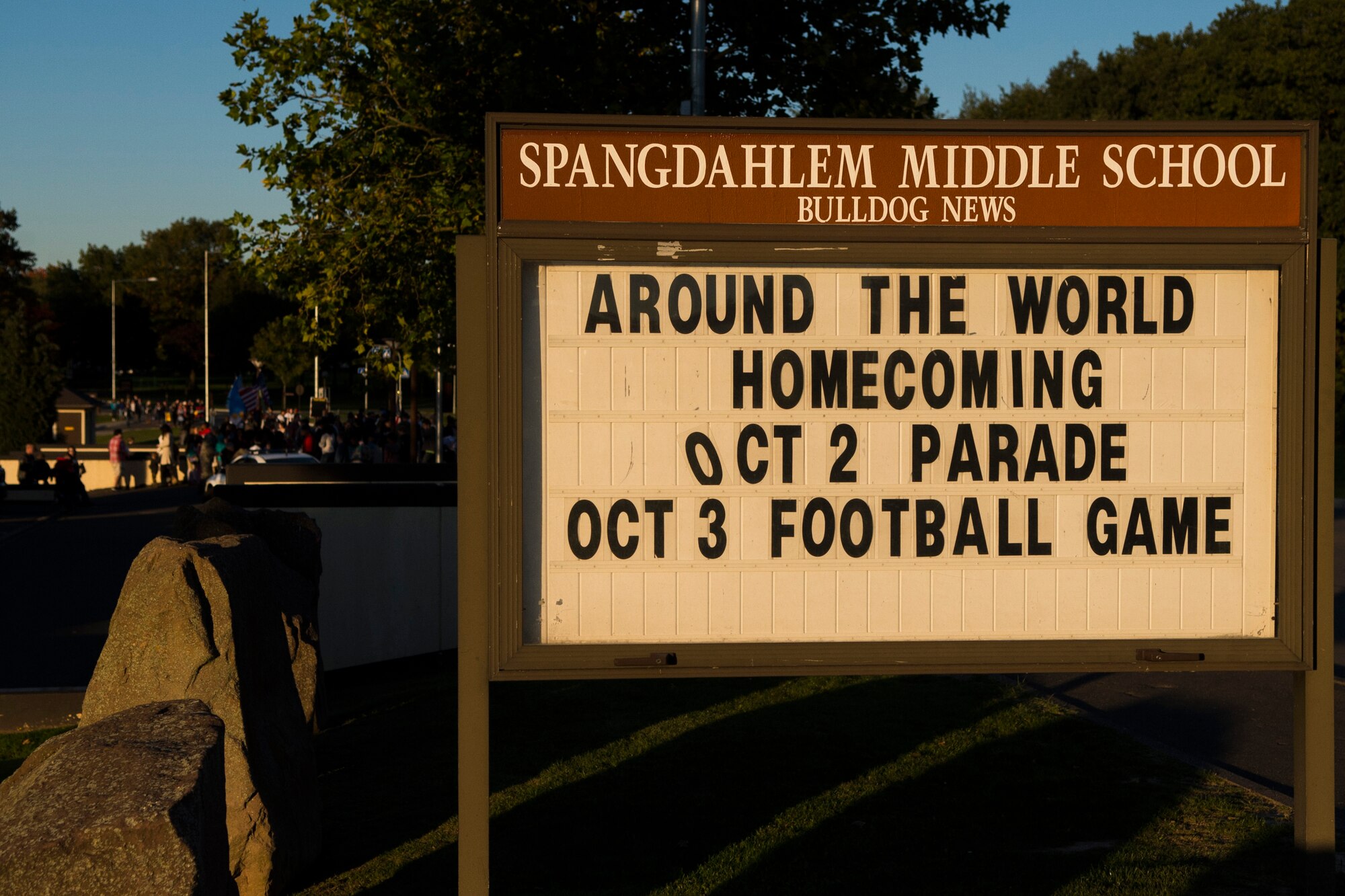 A sign promoting Homecoming weekend sits outside Spangdahlem Middle School before the start of a Homecoming parade at Spangdahlem Air Base, Germany, Oct. 2, 2015. This year’s theme for Homecoming was ‘Around the World’ which included each grade representing a different location, culture and time period across the globe. (U.S. Air Force photo by Airman 1st Class Luke Kitterman/Released)