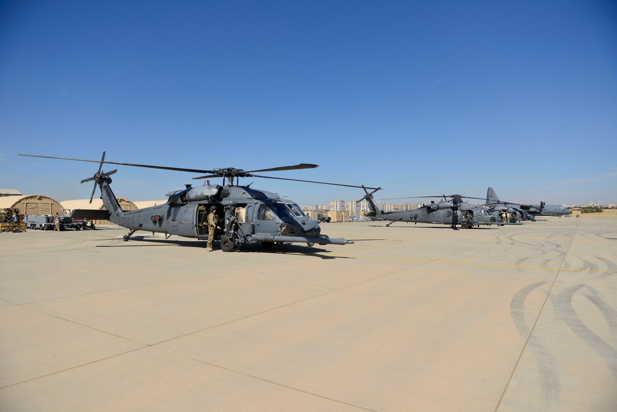 Two HH-60G Pave Hawk Helicopters sit on the flight line at Diyarbakir Air Base, Turkey Oct. 1, 2015. U.S. Air Forces Central Command has begun staging small detachments of aircraft and Airmen at Diyarbakir AB in southeast Turkey to enhance Coalition capabilities. When requested, the helicopters will personnel provide recovery support to protect and recover Coalition members. (U.S. Air Force photo by Airman 1st Class Cory Bush)