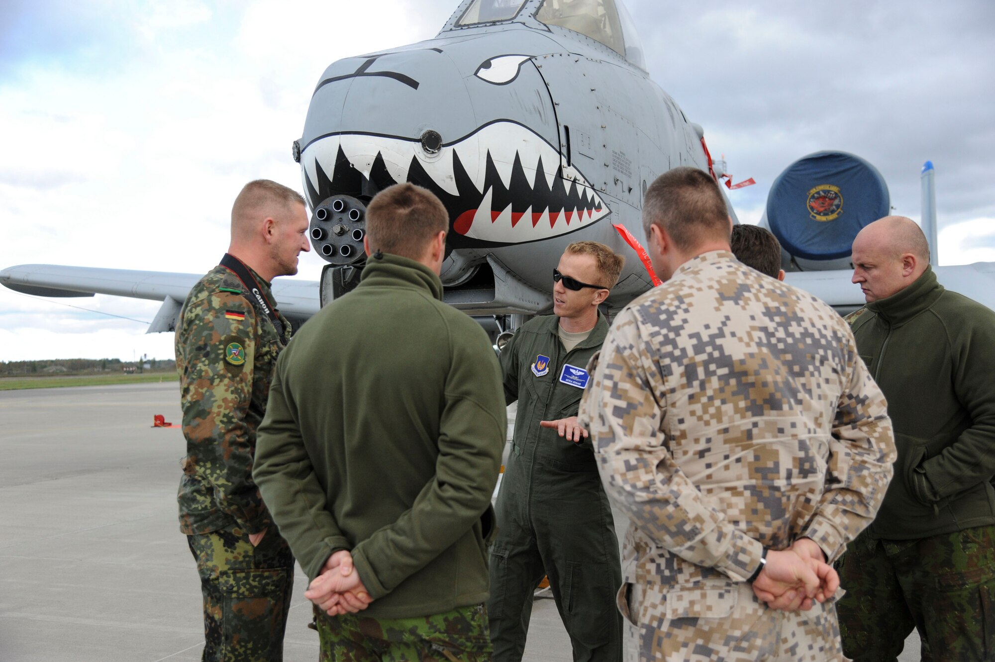 U.S. Air Force Maj. Dan Edgar, 74th Expeditionary Fighter Squadron director of operations (middle), shares a personal experience with members of the Baltic Defense College during a tour at Amari Air Base, Estonia, Sept 30, 2015. The 74th EFS, deployed as part of a Theater Security Package, provided the group with an up-close and personal look of the A-10 Thunderbolt II attack aircraft. (U.S. Air Force photo by Andrea Jenkins/Released)