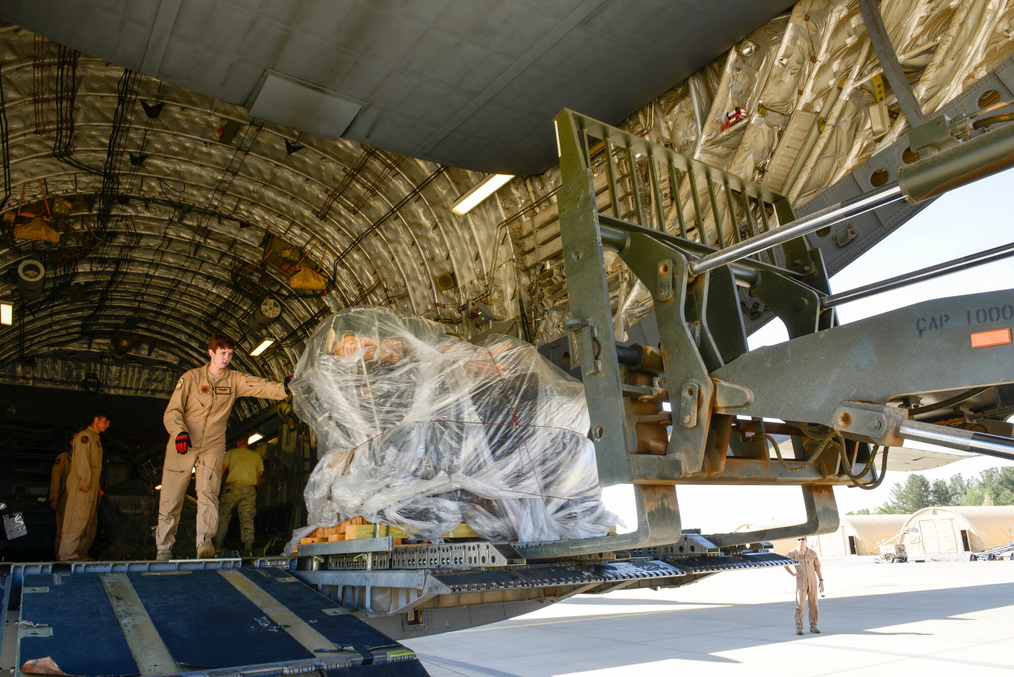 Senior Airman Ashley Igulo, 14th Airlift Squadron loadmaster, off-loads cargo, Sept. 28, 2015, in support of U.S. Air Forces Central Command personnel recovery mission at Diyarbakir Air Base, Turkey. The U.S. Air Force has delivered over 680 tons of cargo to Diyarbakir Air Base to prepare for the personnel recovery operations. (U.S. Air Force photo by Airman 1st Class Cory W. Bush/Released)
