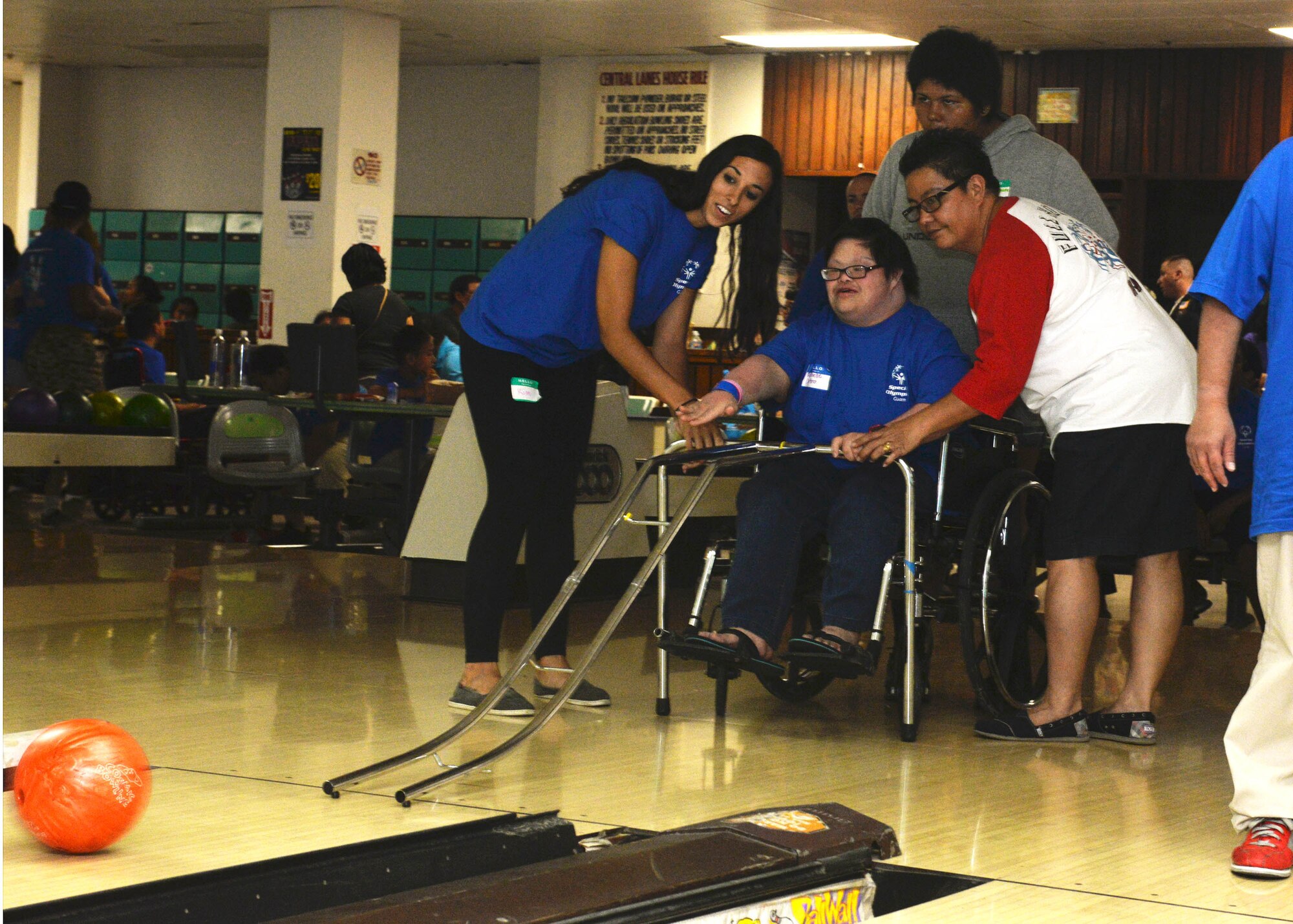 Staff Sgt. Kimberly Chroniak, 36th Maintenance Squadron, assists a Special Olympics Guam athlete Oct. 3, 2015, at a bowling center in Tamuning, Guam.    Service members dedicated eight weeks to coach participants for the event which included 125 athletes with intellectual disabilities. (U.S. Air Force photo by Senior Airman Joshua Smoot/Released)