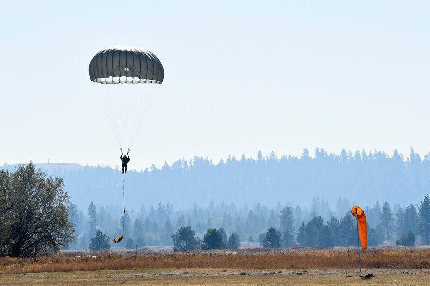 Survival, Evasion, Resistance and Escape specialists jump from a UH-1N Iroquois helicopter during a parachute demonstration Sept. 29, 2015, at Fairchild Air Force Base, Wash. The demonstration was part of an Air Education and Training Command civic leader visit, which included Lt. Gen. Darryl Roberson, AETC commander. (U.S. Air Force photo/Airman 1st Class Mackenzie Richardson)