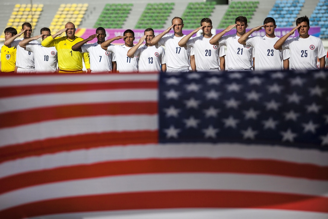 The U.S. men's soccer team renders honors to the U.S. flag before the game against the Qatar men's soccer team during the 6th CISM Military World Games in Mungyeong, South Korea, Oct. 4, 2015. U.S. Marine Corps photo by Cpl. Jordan Gilbert