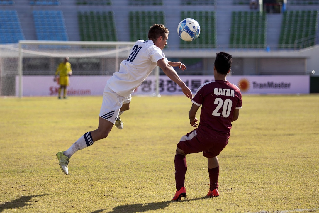 U.S. men's soccer team player Caleb Downey, left, heads the ball away from a Qatar men's soccer team during the 6th CISM Military World Games in Mungyeong, South Korea, Oct. 4, 2015.  U.S. Marine Corps photo by Cpl. Jordan Gilbert
