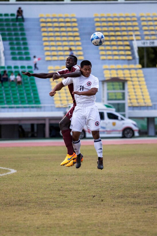 U.S. men's soccer team player Christopher Afaisen, right, heads the ball away from a Qatar men's soccer team during the 6th CISM Military World Games in Mungyeong, South Korea, Oct. 4, 2015.  U.S. Marine Corps photo by Cpl. Jordan Gilbert