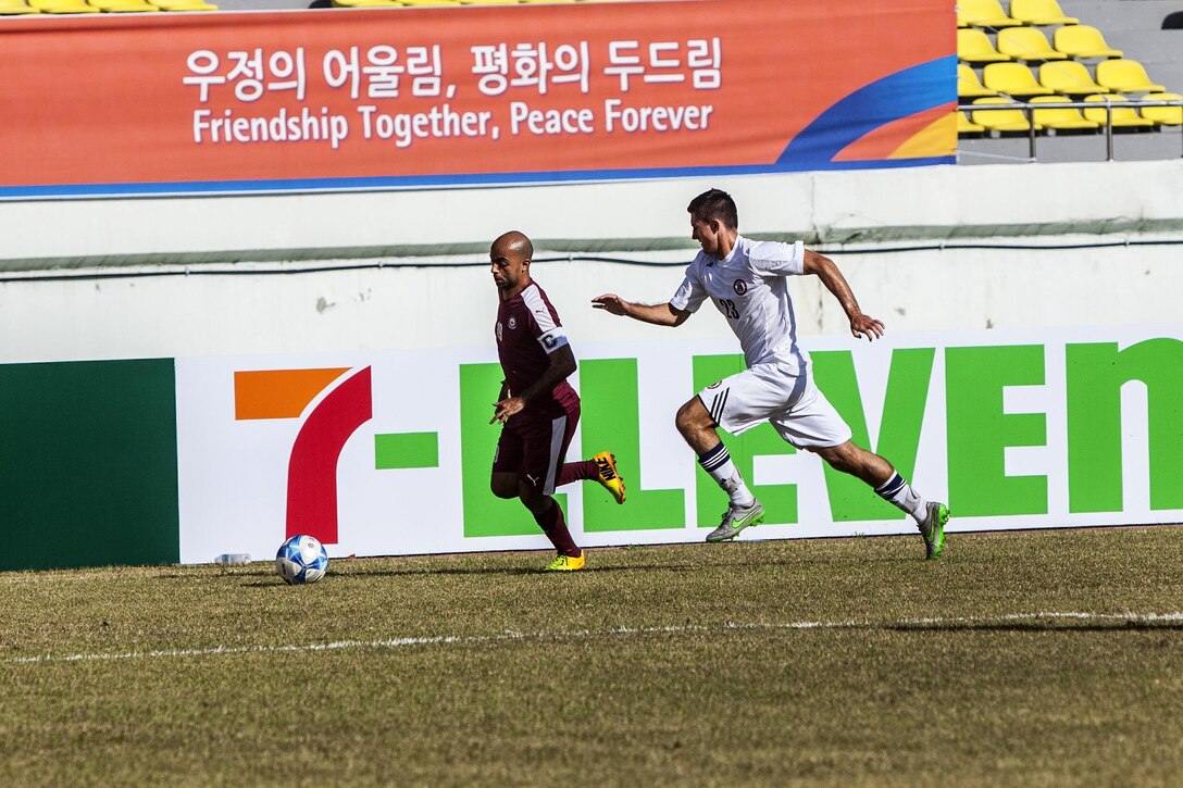 U.S. men's soccer team player Alexander Wilson, right, runs after the ball against a Qatar men's soccer team player during the 6th CISM Military World Games in Mungyeong, South Korea, Oct. 4, 2015. U.S. Marine Corps photo by Sgt. Ashley Cano 