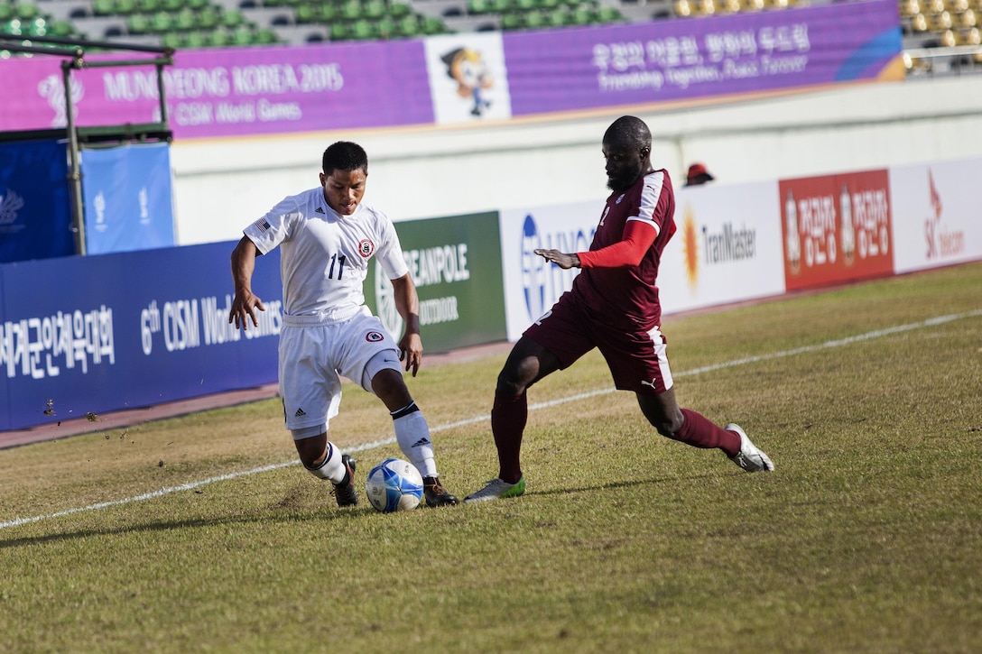 U.S. men's soccer team player Christopher Afaisen, left, steals the ball from the Qatar men's soccer team during the 6th CISM Military World Games in Mungyeong, South Korea, Oct. 4, 2015. U.S. Marine Corps photo by Sgt. Ashley Cano 