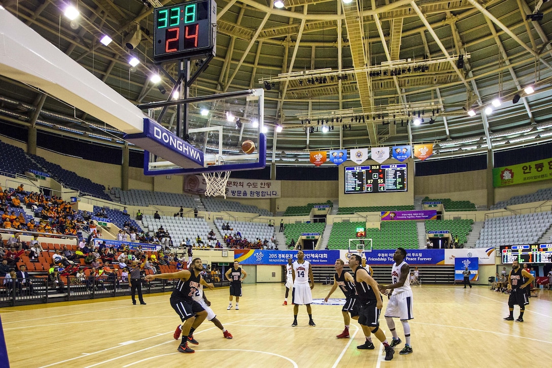 A U.S. men's basketball team player attempts a free throw against the Canadian team during at the 6th CISM Military World Games in Mungyeong, South Korea, Oct. 3, 2015.  U.S. Marine Corps photo by Sgt. Ashley Cano