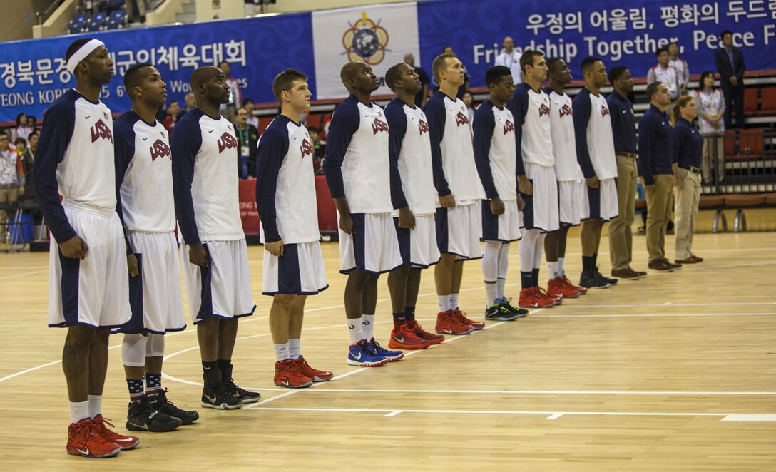 The U.S. men's basketball team stands at attention for the national anthem before their game against the Canadian men’s basketball team during the 6th CISM Military World Games in Mungyeong, South Korea, Oct. 3, 2015. U.S. Marine Corps photo by Sgt. Ashley Cano