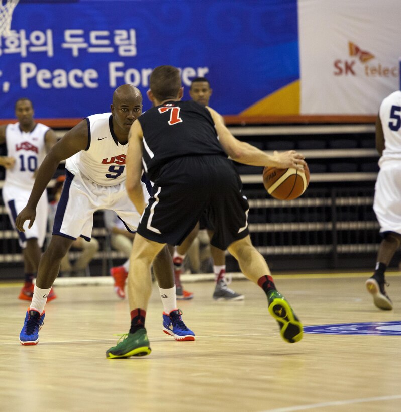 A U.S. men's basketball team player, foreground left, plays defense against a Canadian basketball team player during the 6th CISM Military World Games in Mungyeong, South Korea, Oct. 3, 2015. U.S. Marine Corps photo by Sgt. Ashley Cano