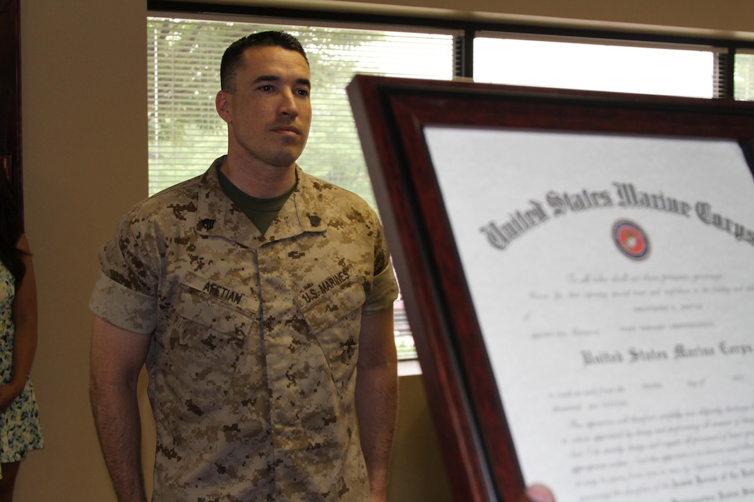 U.S. Marine Corps Staff Sgt. Christopher B. Afetian, from Las Vegas, Nevada, stands at the position of attention while his meritorious promotion warrant is read July 2, 2015, at Recruiting Station Frederick in Frederick, Maryland. The board consisted of a Marine Corps physical fitness test and job performance evaluation. (U.S. Marine Corps photo by Sgt. Anthony J. Kirby/Released)