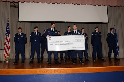 Capt. Andrew Shebelut, 342nd Training Squadron Tactical Air Control Party School class leader, presents a check of $1,000 to Master Sgt. Eduardo Ramos, 342nd TRS TACP Schoolhouse operations superintendent, who accepts on behalf of the TACP schoolhouse during the TACP class graduation Aug. 12, 2015 at the Joint Base San Antonio-Lackland Medina Annex, Texas. The money was a donation from the graduating class to the schoolhouse. The class was the first to graduate from the schoolhouse since it relocated to JBSA from Hulburt Field Air Force Base, Fla.