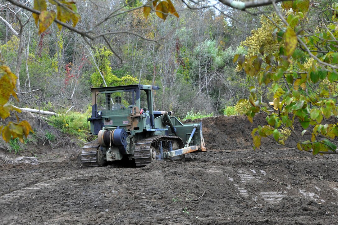 A soldier operates a bulldozer to clear space near Normanskill Creek in Albany, N.Y., Friday, Oct. 2, 2015 as part of New York's preparations for the possible landfall of Hurricane Joaquin. The soldier is assigned to the New York Army National Guard's 204th Engineer Battalion. At the direction of Gov. Andrew M. Cuomo members of the battalion were mobilized to work with the New York State Department of Environmental Conservation to clear obstructions from waterways which could cause flooding during a heavy rainfall. New York Army National Guard photo by Sgt. Major Corine Lombardo