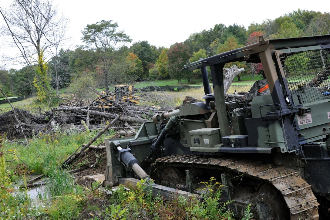 A soldier operates a bulldozer to clear space near Normanskill Creek in Albany, N.Y., Friday, Oct. 2, 2015 as part of New York's preparations for the possible landfall of Hurricane Joaquin. The soldier is assigned to the New York Army National Guard's 204th Engineer Battalion. New York Army National Guard photo by Sgt. Major Corine Lombardo