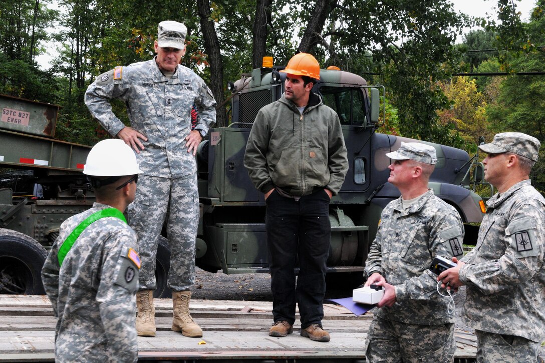 New York Army National Guard, Maj. Gen. Patrick A. Murphy, center left, adjutant general, receives a briefing from several soldiers and Brian Perez, center right, a maintenance assistant with the Department of Environmental Conservation, in preparation for Hurricane Joaquin, in Shandanken, N.Y., Oct. 2, 2015. New York Army National Guard photo by Sgt. Michael Davis 