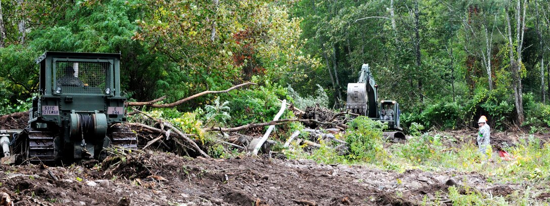 Soldiers operate a bulldozer and hydraulic excavator to clear debris from the shoreline of Esopus Creek as part of the cleanup mission in preparation for Hurricane Joaquin, in Shandanken, N.Y., Oct. 2, 2015. New York Army National Guard photo by Sgt. Michael Davis