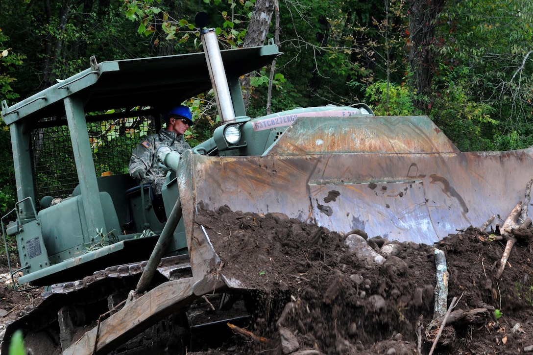 Army Spc. Dakota Nelson operates a bulldozer as part of the debris cleanup mission in preparation for Hurricane Joaquin, in Shandanken, N.Y., Oct. 2, 2015. Nelson is a heavy equipment operator assigned to the New York Army National Guard’s 827th Engineer Company. New York Army National Guard photo by Sgt. Michael Davis