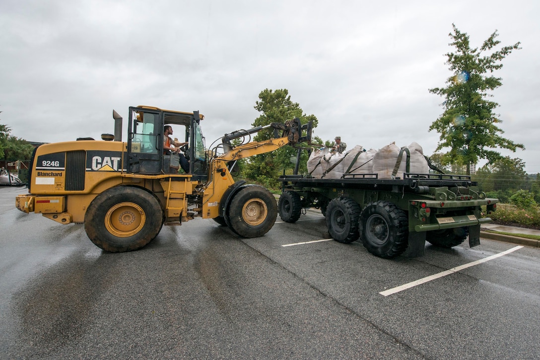 South Carolina Army National Guard members deliver sandbags to the Columbia Riverfront Canal in Columbia, S.C., Oct. 5, 2015. South Carolina National Guard photo by Air Force Tech. Sgt. Jorge Intriago