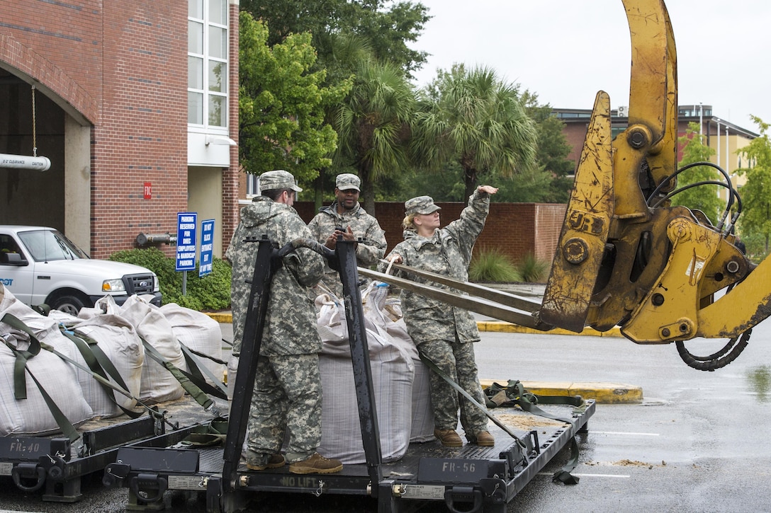 Soldiers deliver sandbags to the Columbia Riverfront Canal in an effort to repair the canal's breached levee in Columbia, S.C., Oct. 5, 2015. South Carolina National Guard photo by Air Force Tech. Sgt. Jorge Intriago