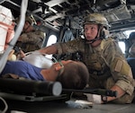 Airman Samual Prescott, a pararescue jumper assigned to the New York Air National Guard's 103rd Rescue Squadron, an element of the 106th Rescue Wing, monitors a patient during a training exercise conducted at F.S. Gabreski Air National Guard Base at Westhampton Beach, New York, on Aug. 25, 2015. The drills was conducted to help evaluate a casualty monitoring system being developed as part of the Air Force BATMAN program, which aims to put useful, wearable technology in the hands of Air Force war fighters. 