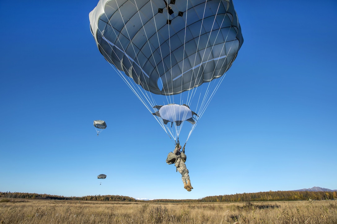 Army Spc. Conner Cota conducts a helicopter jump on Malemute drop zone, Joint Base Elmendorf-Richardson, Alaska, Sept. 24, 2015. Cota is assigned to Company E, 6th Brigade Engineer Battalion. U.S. Air Force photo by Alejandro Pena  