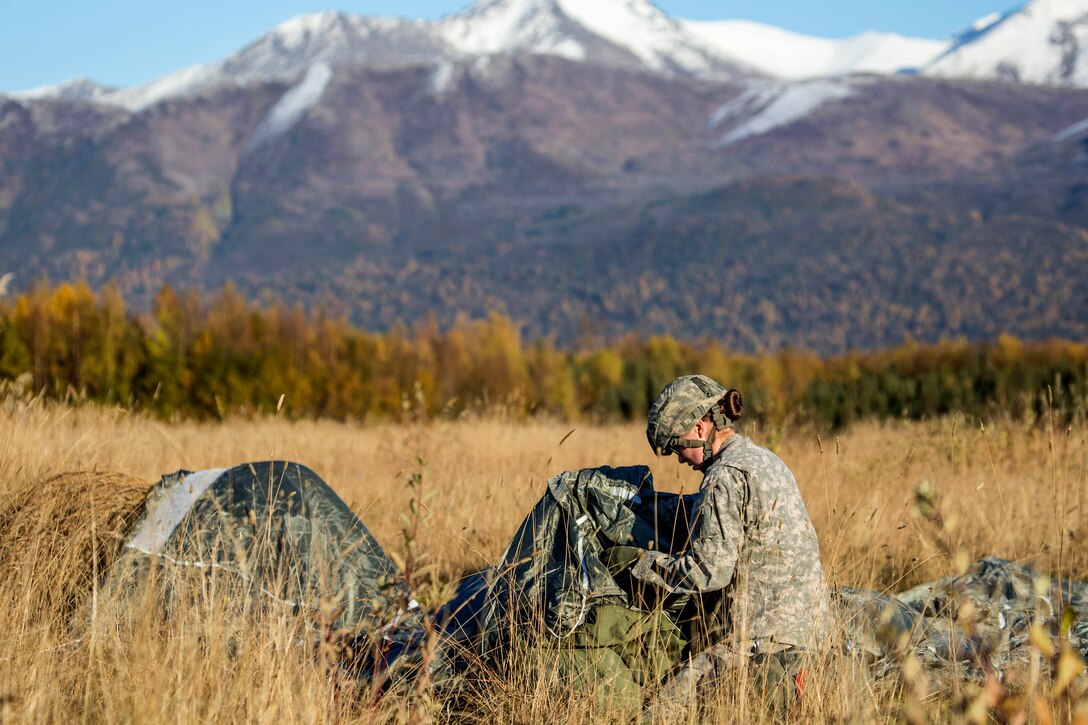 Army Spc. Courtney Peterson recovers her parachute after conducting a helicopter jump on Malemute drop zone, Joint Base Elmendorf-Richardson, Alaska, Sept. 24, 2015. Peterson is assigned to 1st Squadron, Airborne, 40th Cavalry Regiment. U.S. Air Force photo by Alejandro Pena