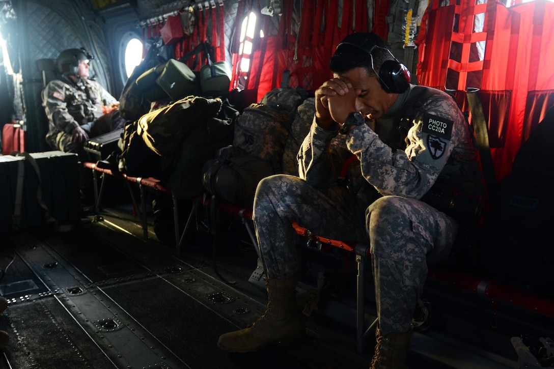 U.S. Army Staff Sgt. Roby Di Giovine travels aboard a C-47 Chinook helicopter over Columbia, S.C., Oct. 5, 2015, during statewide flood response efforts. The South Carolina National Guard has been activated to support state and county emergency management agencies and local first responders as historic flooding impacts counties statewide. Giovine is a photojournalist assigned to the 108th Public Affairs Detachment, South Carolina National Guard. South Carolina National Guard photo by Air Force Airman Megan Floyd