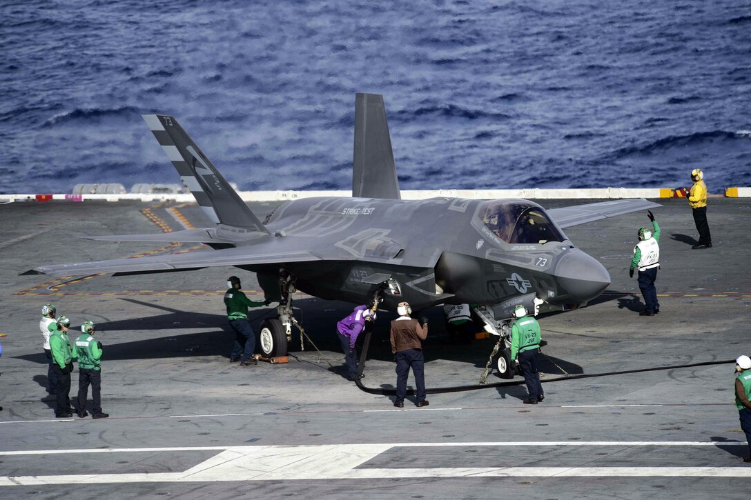 U.S. sailors refuel an F-35C Lightning II carrier-variant joint strike fighter on the flight deck of the aircraft carrier USS Dwight D. Eisenhower in the Atlantic Ocean, Oct. 4, 2015. The F-35C Lightning II Patuxent River Integrated Test Force is currently conducting follow-on sea trials aboard the Eisenhower. The sailors are assigned to Air Test and Evaluation Squadron 23. U.S. Navy photo by Petty Officer 3rd Class Jameson E. Lynch