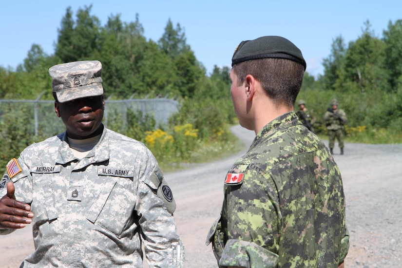 Sgt. 1st Class Oniel Murray of the Fort Leonard Wood, Mo., 1st Brigade Engineers discusses the differences in teaching techniques with his Canadian counterpart, Canadian Armed Forces Sergeant Corey Struss at the Canadian Forces School of Military Engineering (CFSME) at Canadian Forces Base Gagetown in New Brunswick, Canada, as part of an instructor exchange initiative between the U.S. and the CFSME, spearheaded by 1st Brigade engineers.