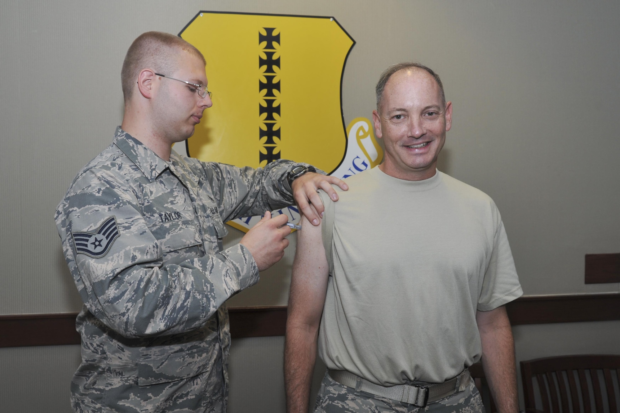 U.S. Air Force Col. Michael L. Downs, 17th Training Wing Commander, receives his flu shot from Staff Sgt. Wesley S. Taylor, 17th Medical Operations Squadron allergies and immunizations technician, at Goodfellow Air Force Base, Texas, Oct. 6, 2015. All active duty military members are required to receive the flu vaccination annually. (U.S. Air Force photo by Airman Chase Sousa/Released)
