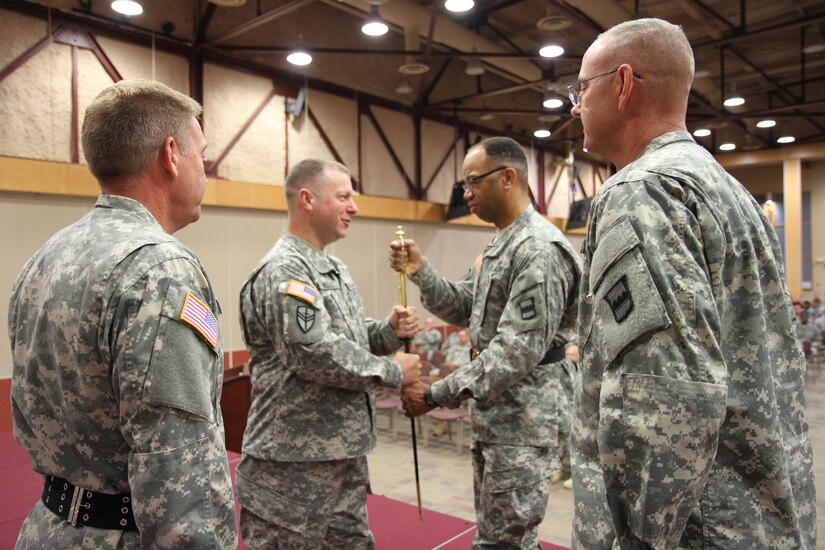 Sgt. Maj. Gerald Brandsasse (left) and Command Sgt. Maj. Jeffrey Darlington observes as Command Sgt. Maj. Jim Wills passes the 80th Training Command's noncommissioned officer sword to Maj. Gen. A.C. Roper, commander 80th TC symbolizing Wills' relinquishment of duties as the command's top noncommissioned officer during a change of responsibility ceremony, Richmond, Va., Aug. 2, 2015. Roper then passed the sword over to Command Sgt. Maj. Jeffrey Darlington making Darlington the new command sergeant major.