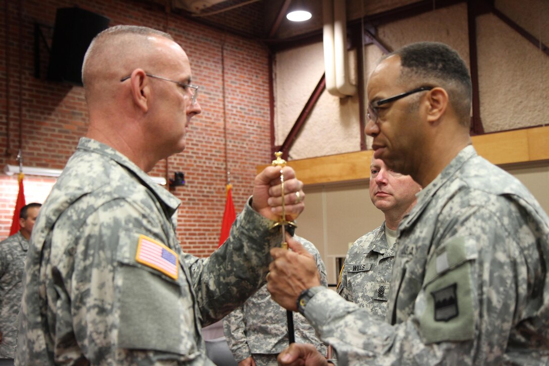 Command Sgt. Maj. Jeffrey Darlington, (left) accepts the noncommissioned officer sword from Maj. Gen. A.C. Roper, commander 80th Training Command (TASS), during a change of responsibility ceremony, Richmond, Va., Aug. 2, 2015. By accepting the sword Darlington officially became the 80th’s command sergeant major.