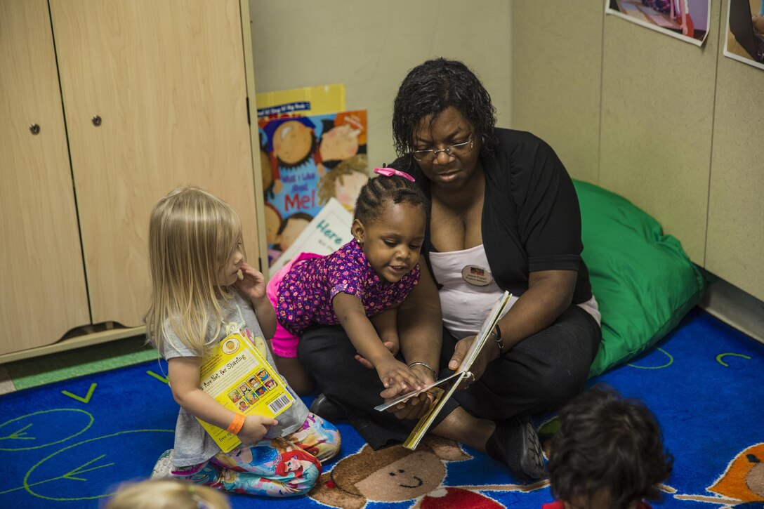 A teacher reads with her students at the child development center aboard Marine Corps Air Station Beaufort Sept. 23. MilitaryChildCare.com is a new website that will provide parents with comprehensive information on military operated child care options. Military families around the world will be able to research and sign up for child care programs. 