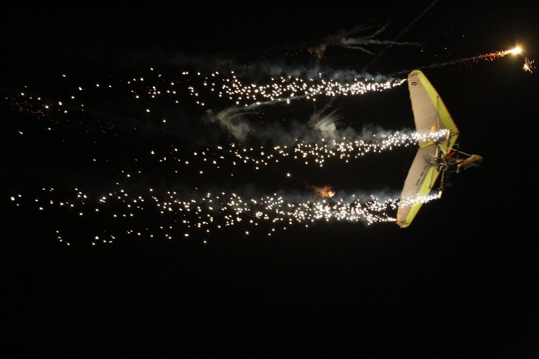 Dan Buchanan pilots an illuminated hang glider during his performance at the 2015 MCAS Miramar Air Show aboard Marine Corps Air Station Miramar, Calif., Oct. 3. Buchanan has accrued more than 2,400 hours of flight time in hang gliders. (U.S. Marine Corps photo by Cpl. Alissa P. Schuning/Released)