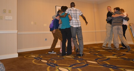 Members of the 80th Training Command Teen Council participate in a game called protons and neutrons during a joint meeting with members of the 412th Theater Engineer Command and the 75th Training Command teen councils in Alexandria, Va., July 28, 2015. The meeting afforded the 80th TC teens an opportunity to share their ideas, challenges, and best practices with members of the 75th TC and the 412th TEC councils.