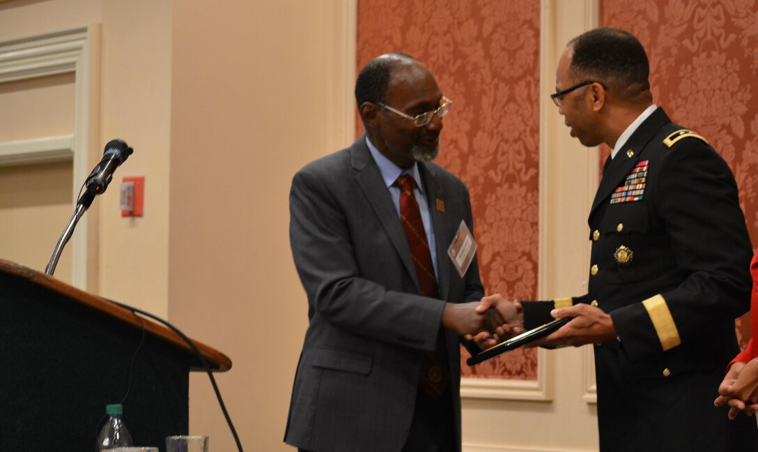 Walter A. Hill, summit chair and dean, College of Agriculture, Environment and Nutritional Science at Tuskegee University, presents Maj. Gen. A. C. Roper, commander 80th Training Command, with a plaque for delivering the keynote address at the Booker T. Washington Centennial Awards Leadership Banquet at Tuskegee University, Tuskegee, Ala., Sept. 24, 2015. The topic of Roper’s speech was “Applying the Principles of Public Service to Leadership in Business and Community.” The Banquet marked the culmination of the Booker T. Washington Economic Development Summit.