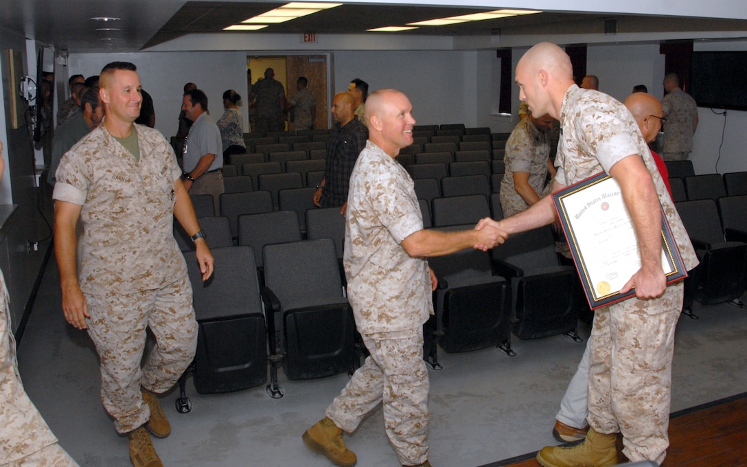 On October 1, 2015 Colonel Scott A. Baldwin, Commanding Officer of Marine Corps Engineer School; congratulates Combat Engineer Instruction Company instructor William E. Satterfield on his promotion to the rank of Gunnery Sergeant aboard Marine Corps Engineer School, Camp Lejeune, North Carolina. 
