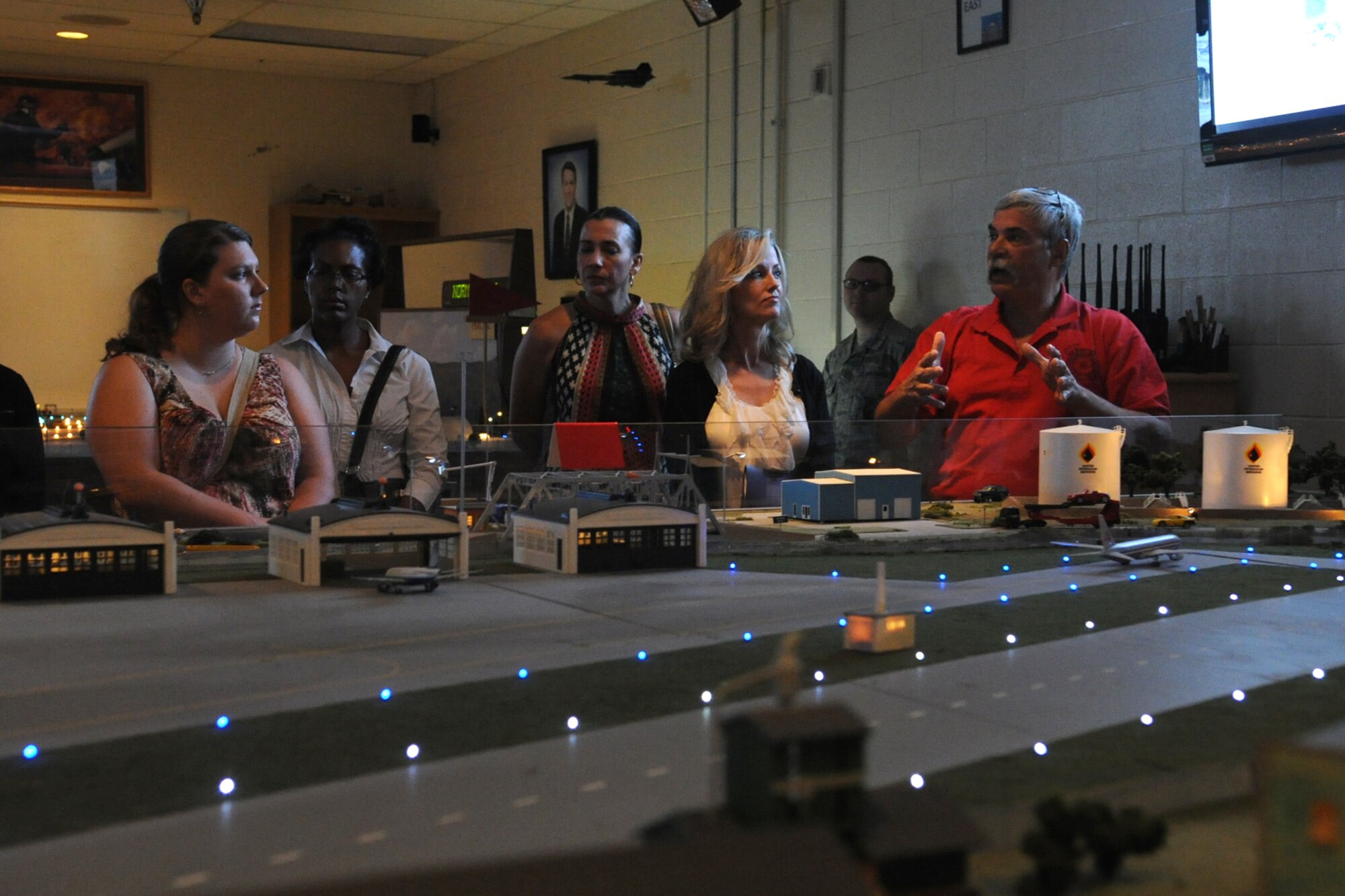 Rodney Born, 312th Training Squadron advanced courses chief, briefs Key Spouses about the Mooresville trainer during an immersion seminar at the Louis F. Garland Department of Defense Fire Academy on Goodfellow Air Force Base, Texas, Oct. 2, 2015. The Mooresville trainer simulates working with city, county and federal jurisdiction during an emergency situation. (U.S. Air Force photo by Staff Sgt. Laura R. McFarlane/Released)  