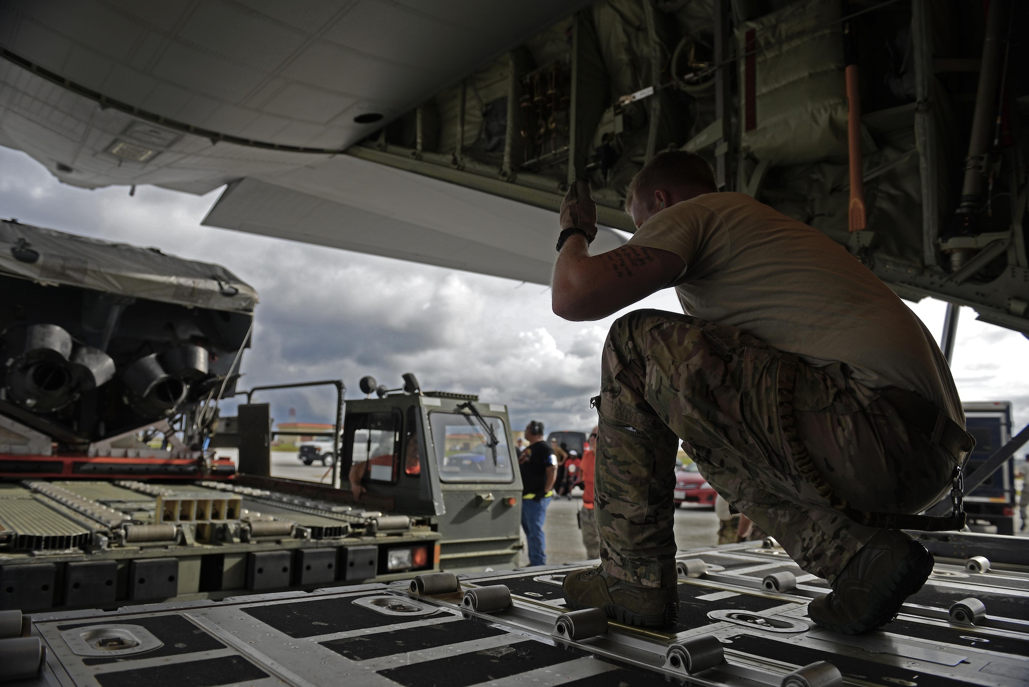A 17th Special Operations Squadron MC-130J Commando II loadmaster, guides the driver of a load carrier toward an MC-130J Commando II during an exercise Sept. 18, 2015, at Andersen Air Force Base, Guam. The MC-130J was part of a dissimilar formation with an MC-130H that completed a Maritime Craft Aerial Delivery System airdrop.  This was the first time an MC-130J Commando II completed the MCADS airdrop in the Pacific.  (U.S. Air Force photo by Staff Sgt. Alexander Riedel)