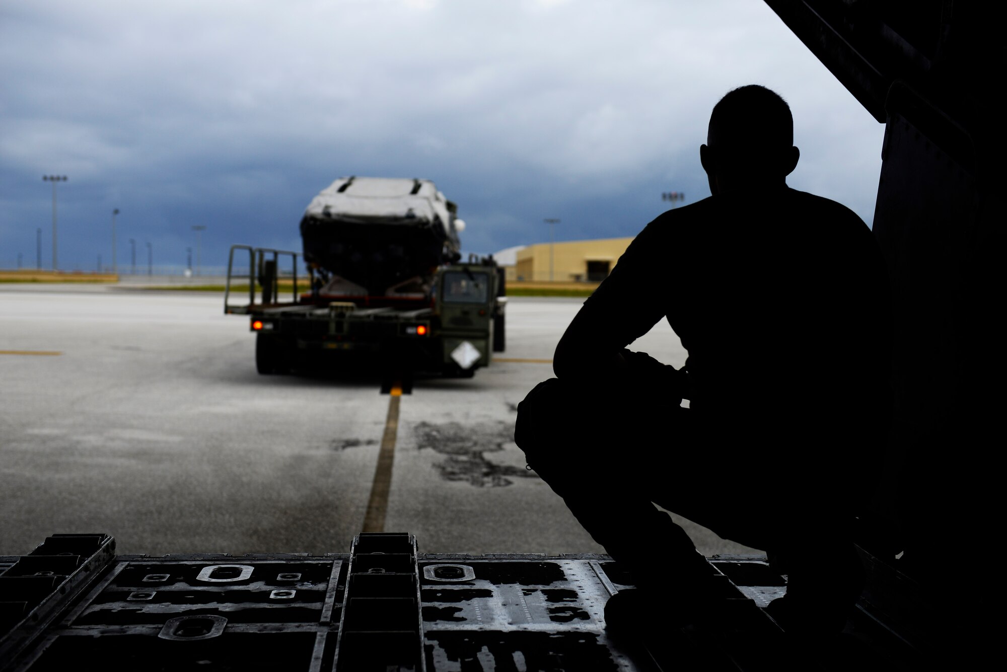 An MC-130H Combat Talon II loadmaster, observes as a load carrier approaches the aircraft during an exercise Sept. 18, 2015, at Andersen Air Force Base, Guam. The MC-130H was part of a dissimilar formation with an MC-130J that completed a Maritime Craft Aerial Delivery System airdrop.  This was the first time an MC-130J Commando II completed the MCADS airdrop in the Pacific.  (U.S. Air Force photo by Staff Sgt. Alexander Riedel)