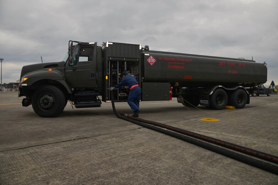 Hiroyuki Sekimoto, 374th Logistics Readiness Squadron fuels management flight, puts the fuel hose back into a fuel truck after refueling a C-130 Hercules at Yokota Air Base, Japan, Oct. 1, 2015. The mission of the fuels management flight is to provide clean and dry aviation fuel to transient and home station aircraft in a safe and timely manner. (U.S. Air Force photo by Senior Airman David Owsianka)