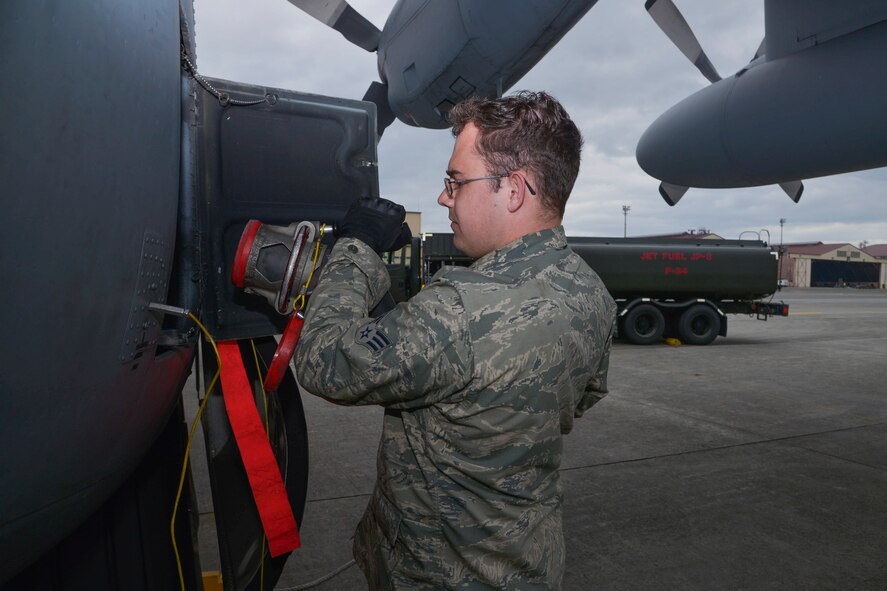 Senior Airman Kyle Berry, 374th Aircraft Maintenance Squadron crew chief, removes the fuel line from a C-130 Hercules at Yokota Air Base, Japan, Oct. 1, 2015. After an aircraft lands, the fuels flight responds to aircraft within 30 minutes. (U.S. Air Force photo by Senior Airman David Owsianka/Released)