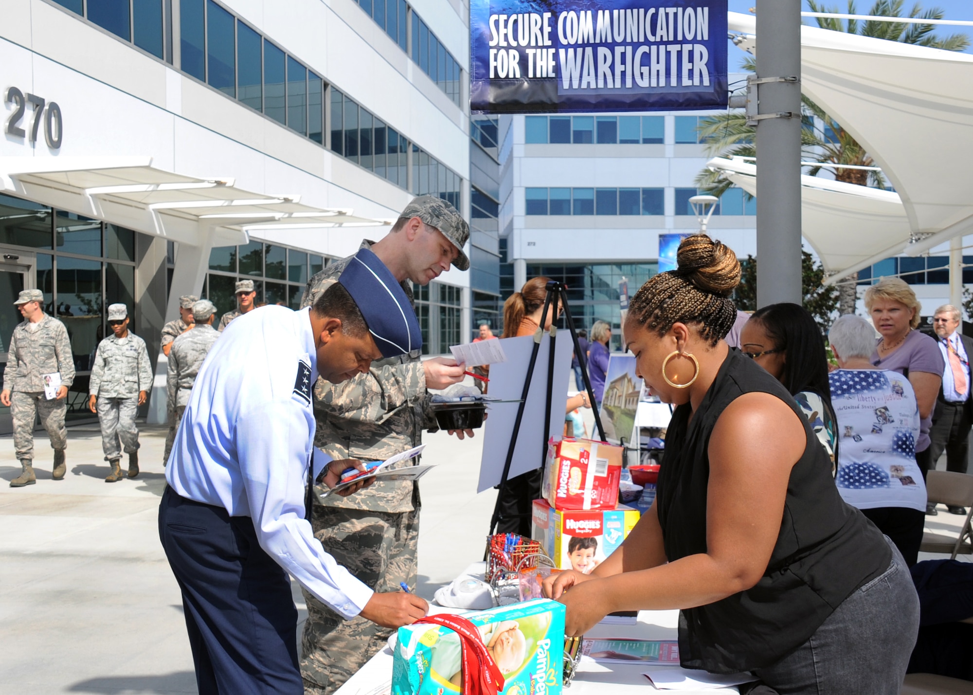 Lt. Gen. Samuel Greaves, SMC commander, talks with a representative from one of the many organizations represented at the CFC kickoff about her charity. Donors can choose from more than 2,500 local and national charities including veterans, cultural, medical, relief, educational, environmental and animal organizations. (U.S Air Force photo by Van Ha)
