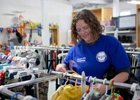 Kari Woods, an Airmen’s Attic volunteer, stocks the children’s clothing section during the facility’s grand re-opening on F.E. Warren Air Force Base, Wyo., Oct. 3, 2015. The Airmen’s Attic is stocked by donated items from the community, and all items are free. (U.S. Air Force photo by Airman 1st Class Malcolm Mayfield)