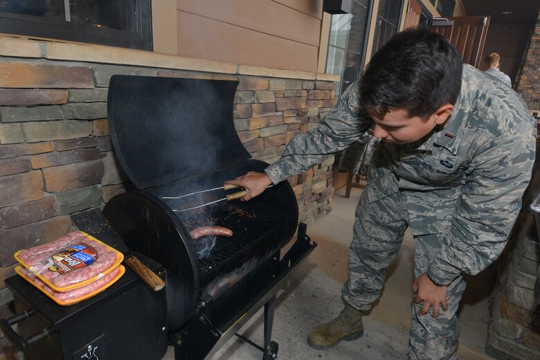 Second Lt. James Carey, 2nd Space Operations Squadron satellite vehicle operator trainee, grills food for 2 SOPS and family members outside the Tierra Vista Community Center at Schriever Air Force Base, Colorado, Friday, Oct. 2, 2015, following a briefing from 2 SOPS leadership explaining Space Mission Force. The 50th Space Wing was chosen by Air Force Space Command to be the first wing to implement SMF. (U.S. Air Force photo/2nd Lt. Darren Domingo)  