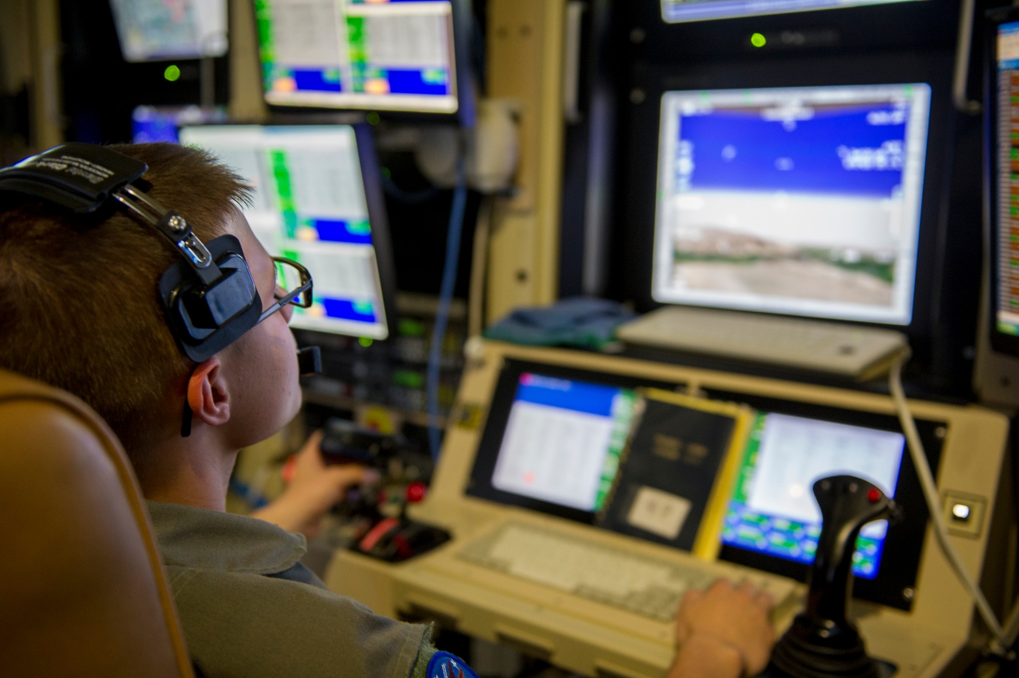 Airman Ryan, a 6th Reconnaissance Squadron student sensor operator, practices tactical operations during an MQ-1 simulator mission. Ryan will train to a variety of missions including intelligence, surveillance, and reconnaissance; close air support; precision strike; and combat search and rescue. Holloman is the premier base for MQ-9 and MQ-1 pilot and sensor operator training, and is projecting over 800 graduates in fiscal year 2016. (U.S. Air Force photo by Senior Airman BreeAnn Sachs)